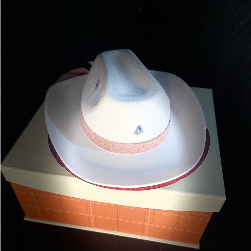 White Cowgirl hat with pink ribbon around brim